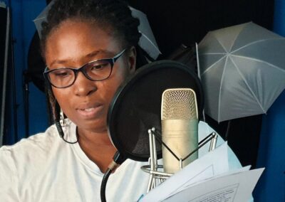Woman in Sound studio recording a lesson in Sierra Leone