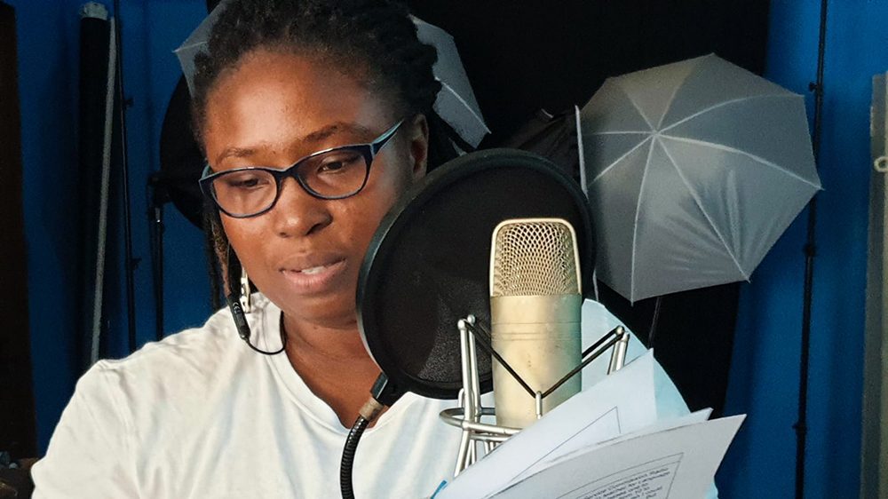 Woman in Sound studio recording a lesson in Sierra Leone