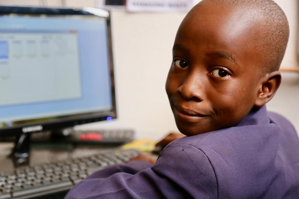 5th grade boy in Zimbabwe at a computer screen