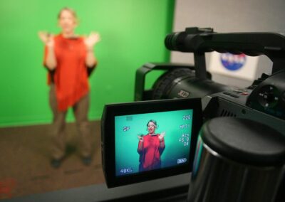 Teacher in studio recording a lesson with a green screen
