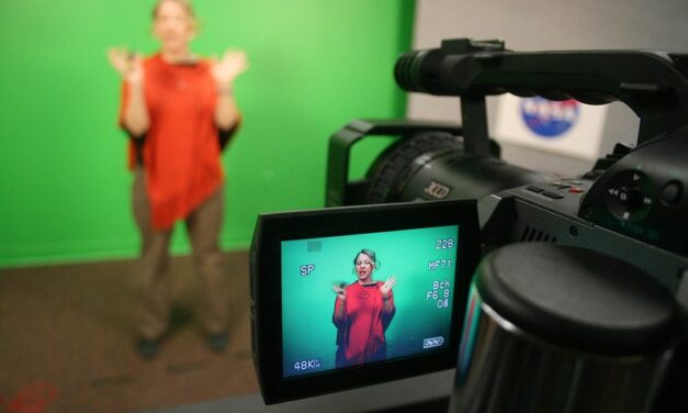 Teacher in studio recording a lesson with a green screen