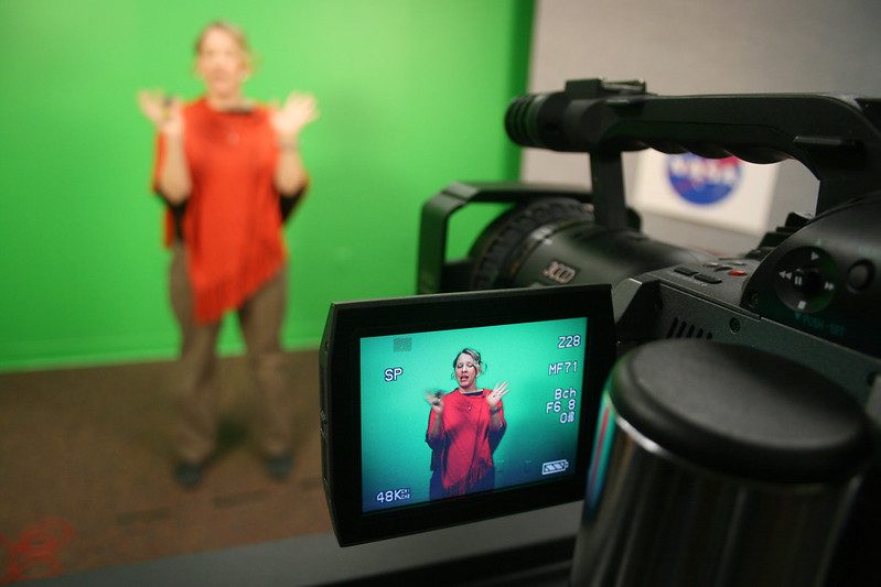 Teacher in studio recording a lesson with a green screen