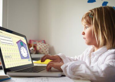 girl working on a educational page with a clock via a laptop