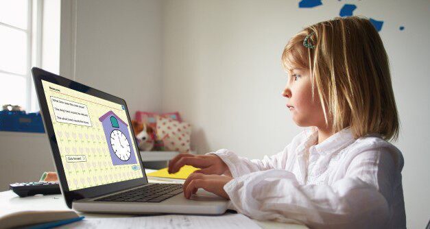 girl working on a educational page with a clock via a laptop