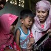 Schooling has stopped, but learning must not Jenaica, 4, (pink headscarf), and her family read together at home, in Mindanao, Philippines. © SavetheChildren/ Hannah Adcock