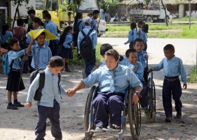 Children outside a school some in wheelchairs