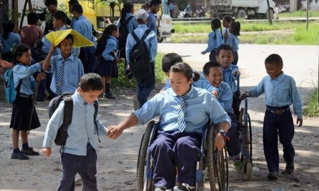 Children outside a school some in wheelchairs