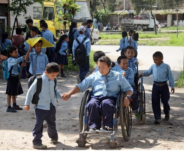 Children outside a school some in wheelchairs