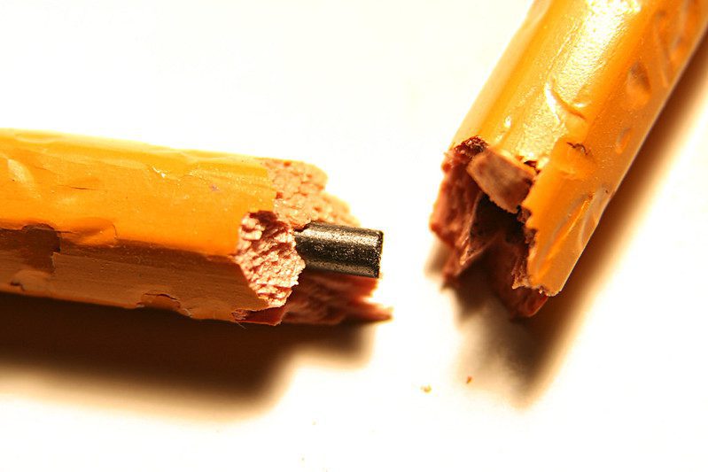 a yellow pencil snapped in half