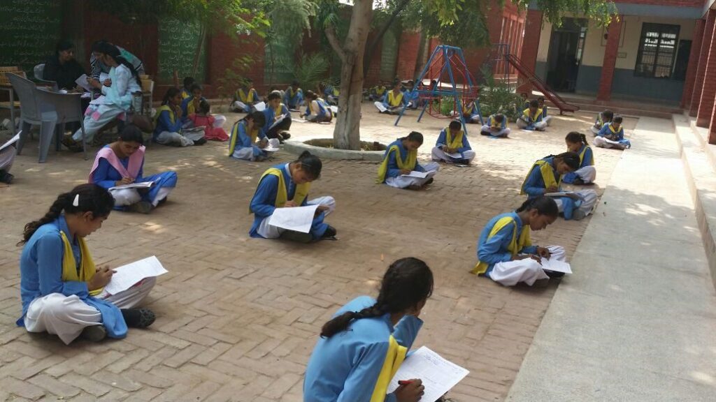 School girls sitting outdoors