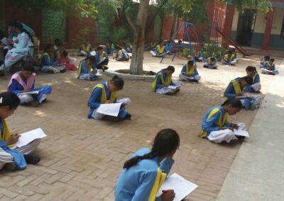 Socially distanced school girls working in outdoor classroom