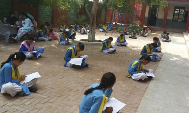 Socially distanced school girls working in outdoor classroom