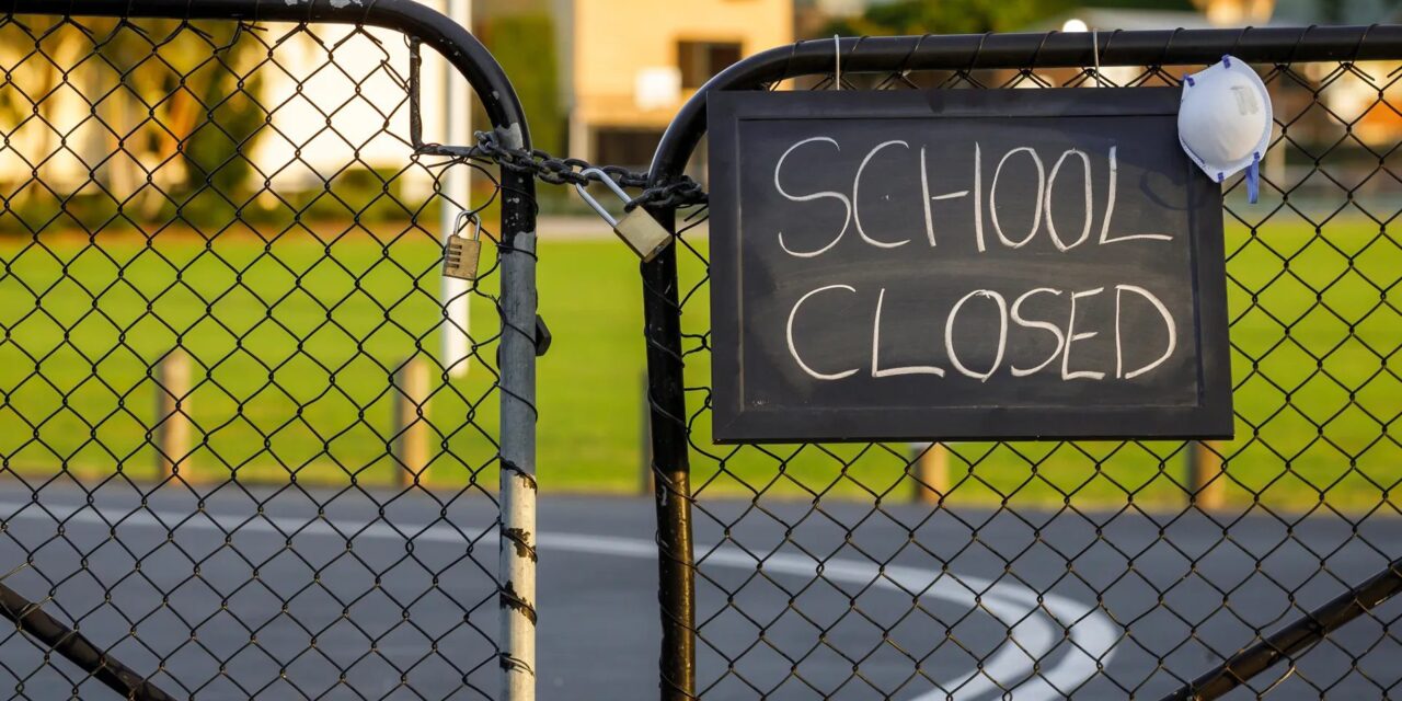 Locked gates with School Closed notice