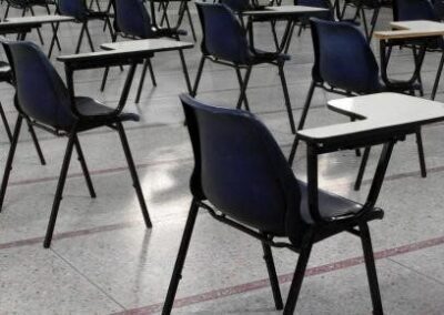 empty chairs with writing arms