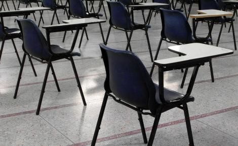 empty chairs with writing arms