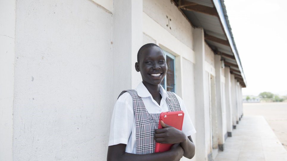 A refugee schoolgirl from south Sudan outside a school in Kenya