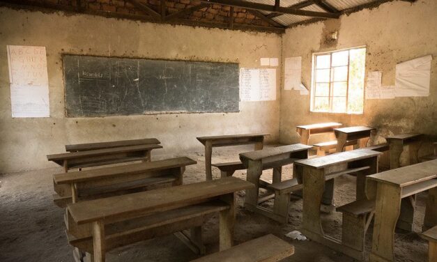 Empty desks and benches in a classroom