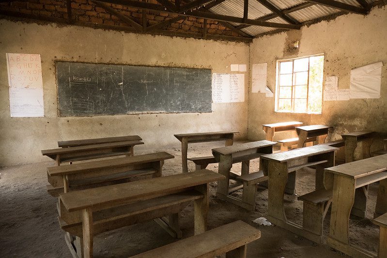 Empty desks and benches in a classroom