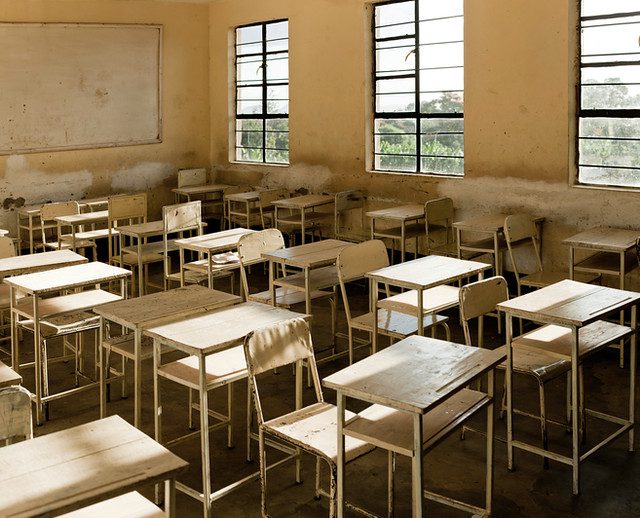 Empty chairs and desks in a classroom