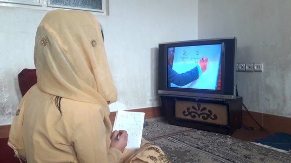 Girl home learning from a tv