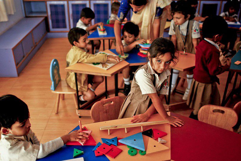 Primary children working with stacking shapes