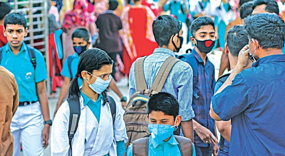 A group of people the majority wearing face masks