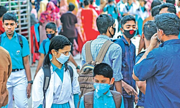 A group of people the majority wearing face masks