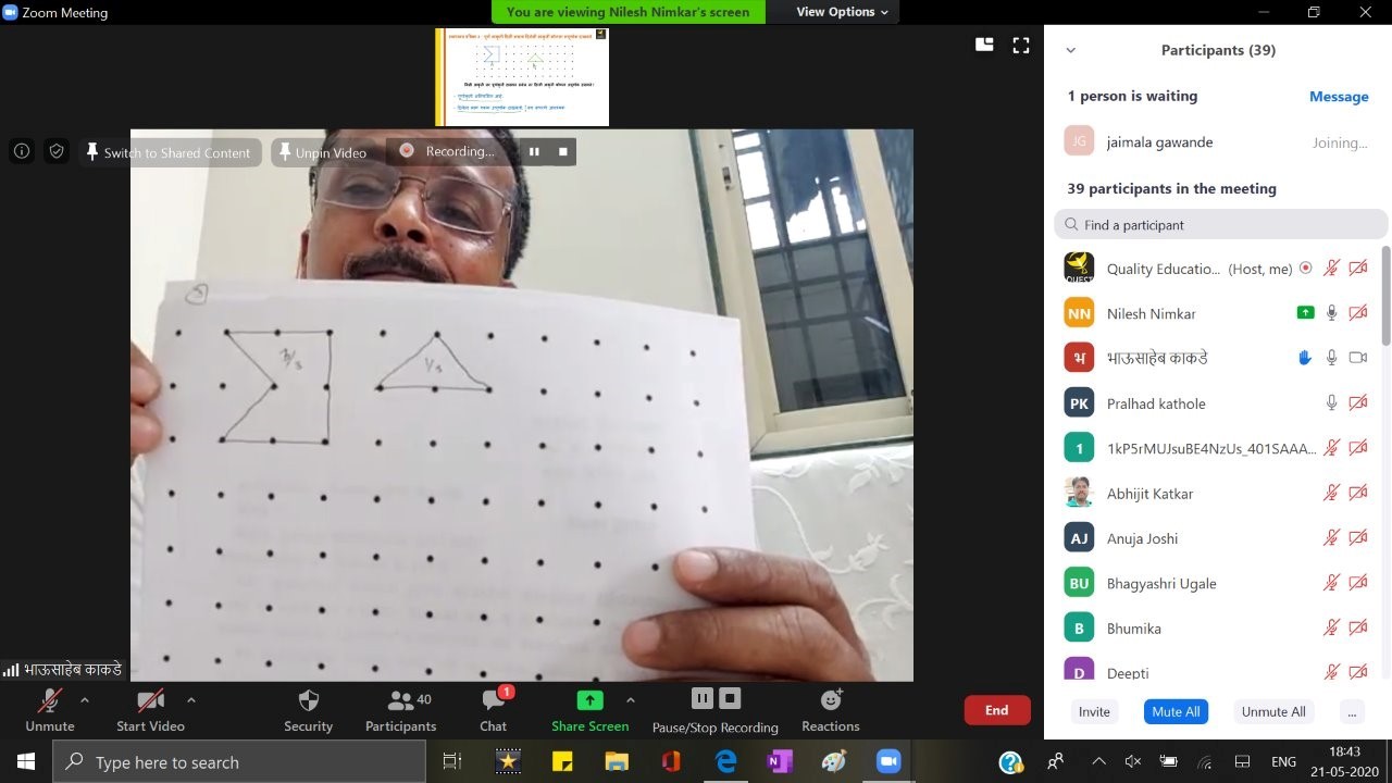Teacher shown via a laptop screen with shapes marked out on dotted/square paper
