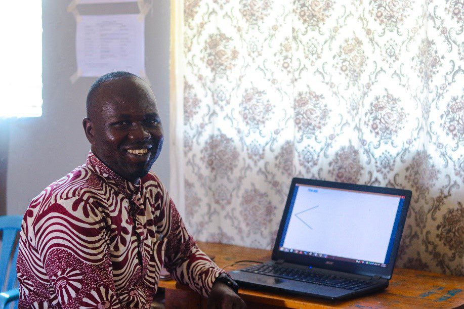 Ugandan male sitting at a laptop