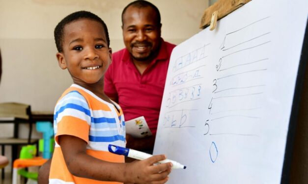 Nigerian father and son at an easel - home learning