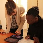 Two adults looking at a tablet computer