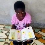 Blind girl in Senegal with books