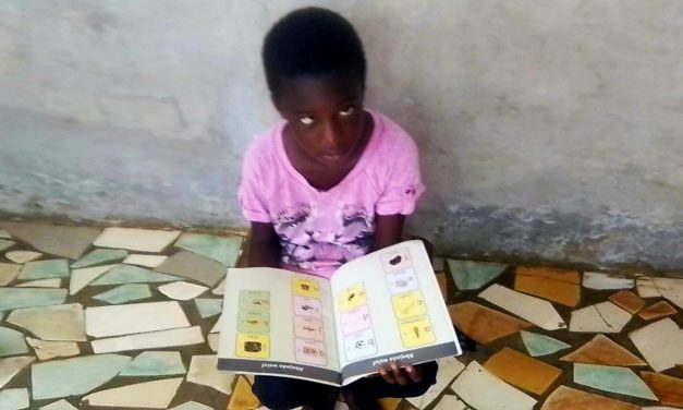Blind girl in Senegal with books