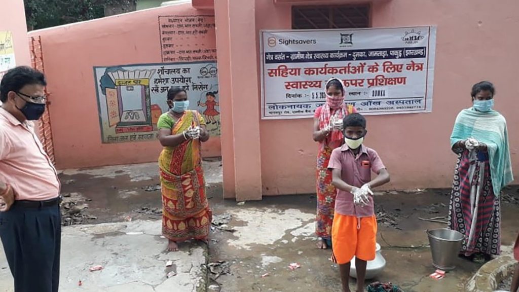 Indian community group of adults and children demonstrating PPE - gloves and masks and handwashing