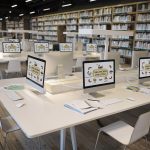 Computer screens as learning stations set up in library setting