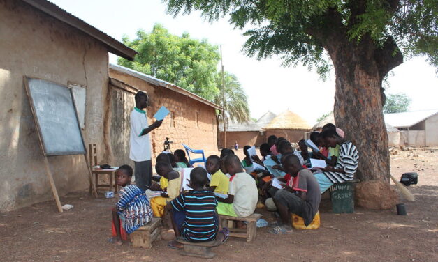 Children being taught in an outdoor classroom in northern Ghana