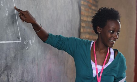 Teacher pointing to chalkboard