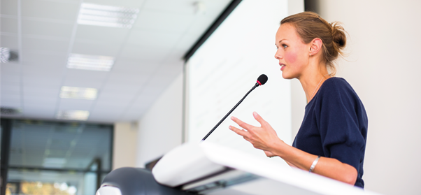 Young woman standing at a lectern