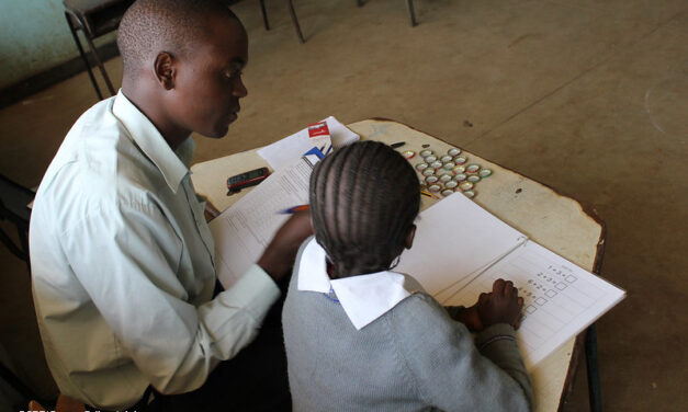 Teacher working with a primary pupil