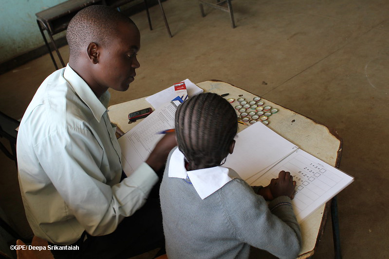 Teacher working with a primary pupil