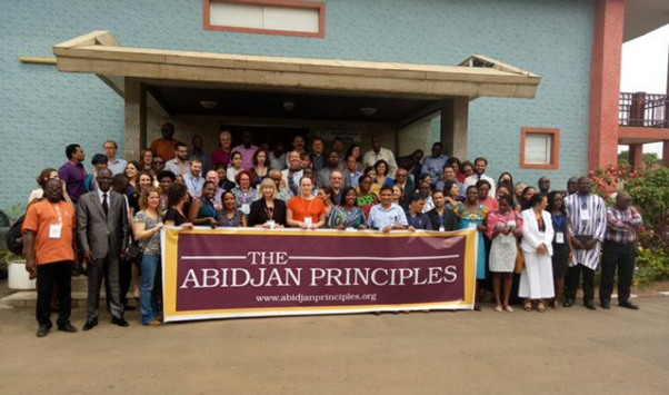 group photo with banner from Abidjan priniciples event