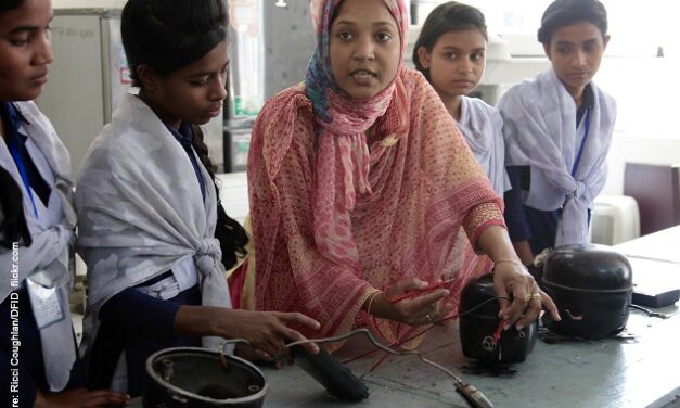 Teacher demonstrating electrical wiring to girl students in Bangladesh