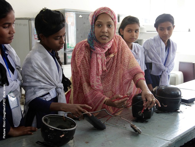 Teacher demonstrating electrical wiring to girl students in Bangladesh