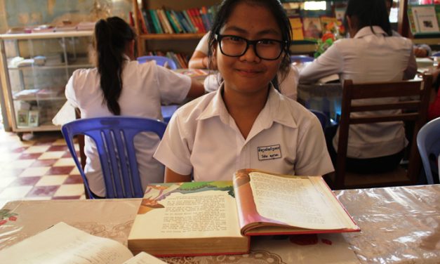 Child at desk with text book