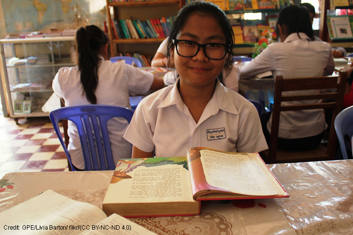 Child at desk with text book