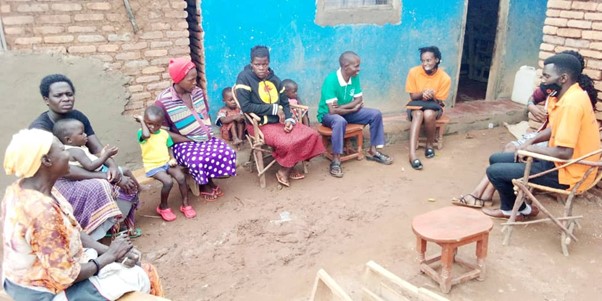 Teacher with parents at school in Uganda