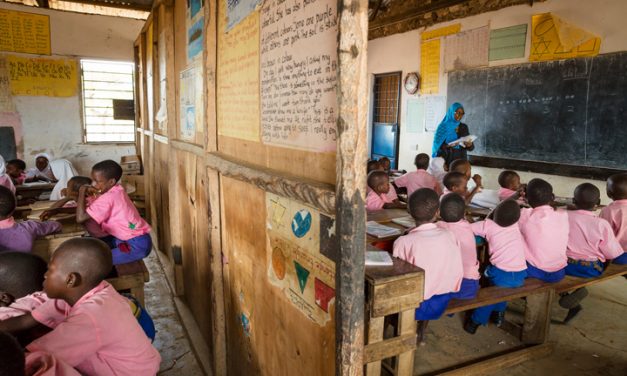 Children in class wearing pink shirts and blue shorts