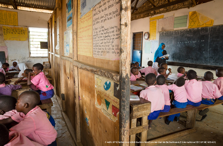 Children in class wearing pink shirts and blue shorts