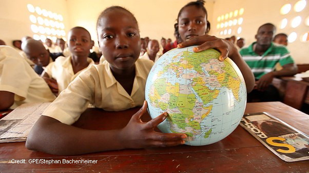 School child in Sierra Leone with globe