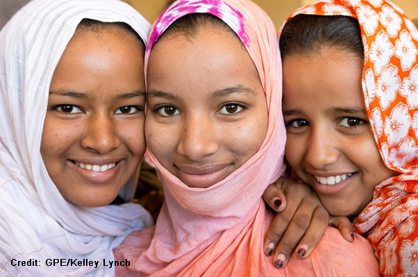 three smiling girls wearing headscarves